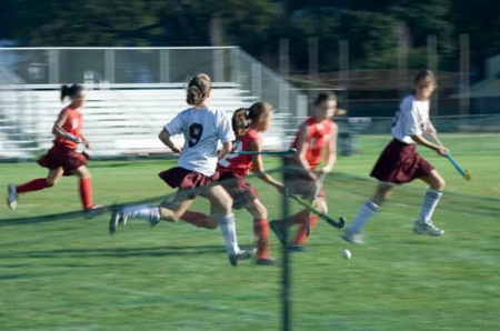 image shows kids playing hocky